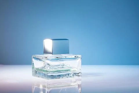Rectangular bottle of perfume on a bright blue background Stock Photos