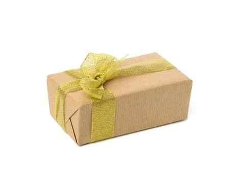 Rectangular box wrapped in brown kraft paper and golden ribbon. Stock Photos