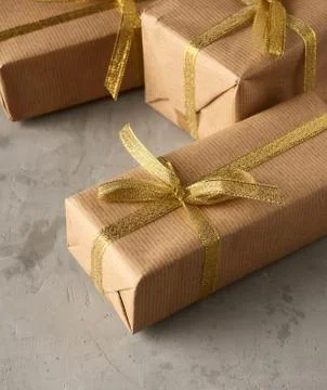 Rectangular box wrapped in brown paper and tied with a silk ribbon with a bow Stock Photos
