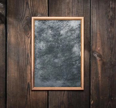 Rectangular brown wooden frame on a background of very old boards Foto stock