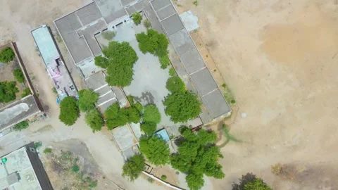 Rectangular Building Complex with Tree-Shaded Courtyard Stock Footage 322976929