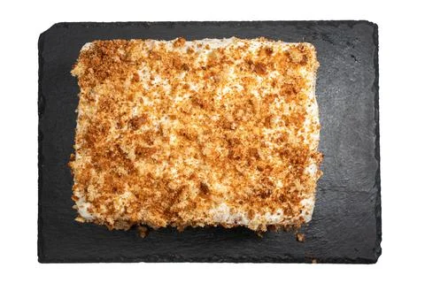 Rectangular cake with whipped cream and crumbs, viewed from above. Stock Photos