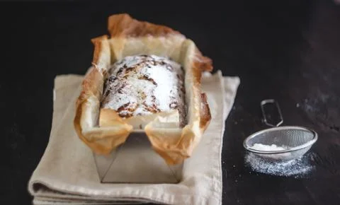 Rectangular capital cupcake with powdered sugar in a metal baking dish on a d Stock Photos