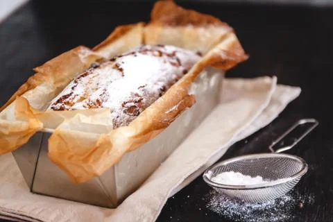 Rectangular capital cupcake with powdered sugar in a metal baking dish on a d Stock Photos