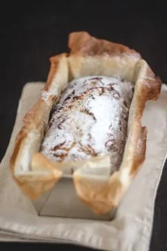 Rectangular capital cupcake with powdered sugar in a metal baking dish on a d Foto stock