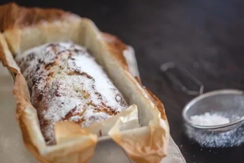 Rectangular capital cupcake with powdered sugar in a metal baking dish on a d Stock Photos
