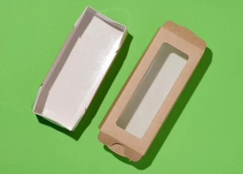 Rectangular cardboard box with a transparent plastic lid on a green backgro.. Stock Photos