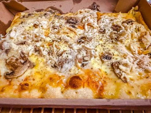 Rectangular chicken and mushroom pizza with melted cheese in cardboard box Stock Photos