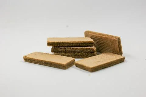 Rectangular chocolate wafer cookies arranged in a pile on white 写真素材