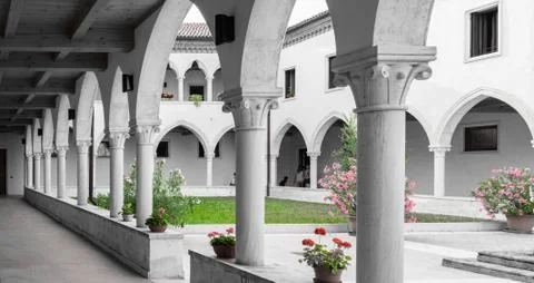 Rectangular cloister with Gothic arches and  columns. Stock Photos