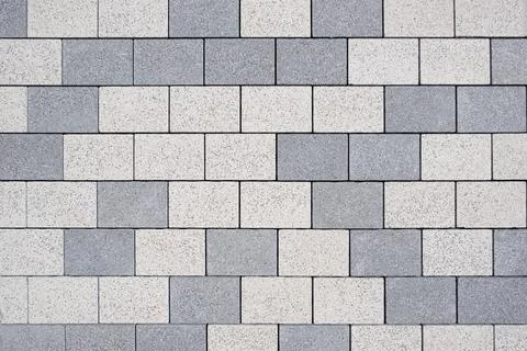 Rectangular concrete paving blocks form a clean geometric pattern. Light an.. Stock Photos