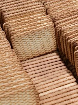 Rectangular cookies arranged in multiple rows inside a box displayed in a s.. Stock Photos