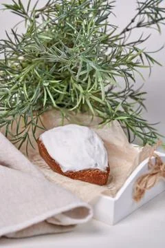 Rectangular cupcake with brown sugar frosting, still life with green branch Stock Photos