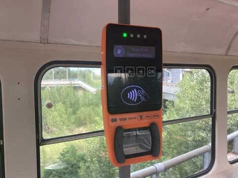 A rectangular device with a lit screen displaying a graphic of a hand pointin Stock Photos