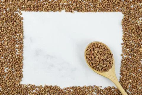Rectangular empty space for text in a buckwheat frame and a wooden spoon with Stock Photos