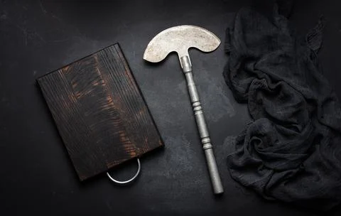 Rectangular empty wooden cutting board and kitchen knife on black table with  写真素材