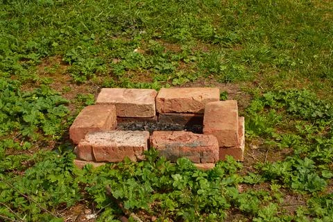 Rectangular fire pit fenced with red brick Stock Photos