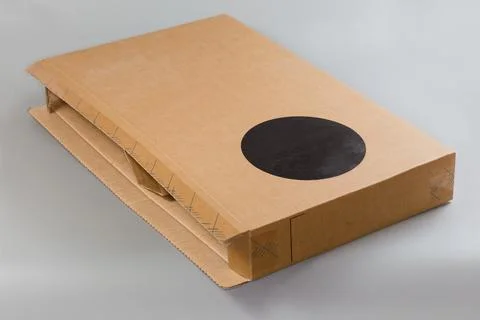 Rectangular flat kraft cardboard packing box lying on its side Stock Photos