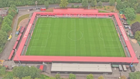 Rectangular football pitch with bright red stands at the Peninsula Stadium 스톡 동영상 315127069