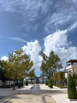 Rectangular fountain on a tiled street between houses Stock Photos