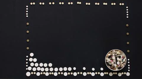 Rectangular frame made up of many white pills on a black handicap Stock Photos