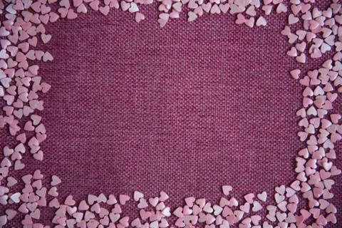 Rectangular frame with small mother-of-pearl hearts on a pink background, Val Stock Photos