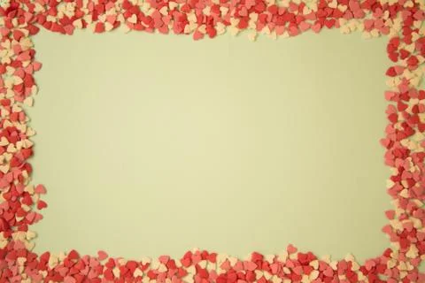 Rectangular frame with small multicolored hearts on a warm yellow background, Stock Photos
