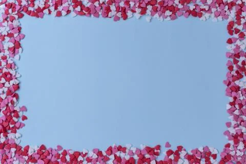 Rectangular frame with small multicolored hearts on a blue background, Valent Stock Photos