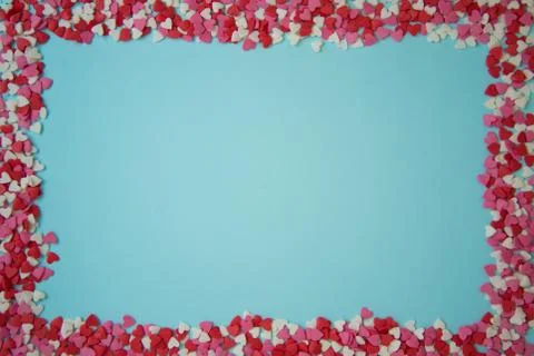 Rectangular frame with small multicolored hearts on a blue background, Valent Stock Photos