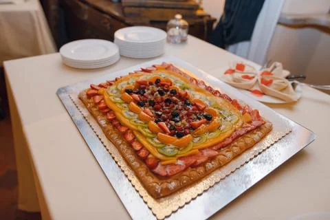 Rectangular fruit tart with strawberries, kiwi, oranges, and berries on a tab Stock Photos
