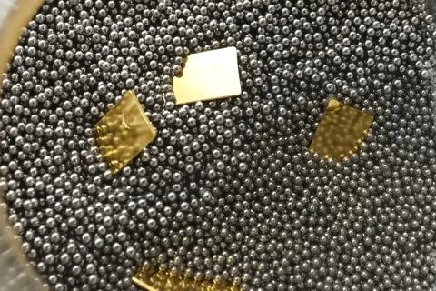 Rectangular gold plates stamped on press. Stock Photos