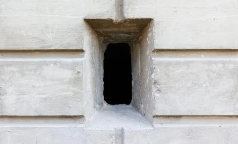 A rectangular hole in the wall. Closeup 스톡 사진