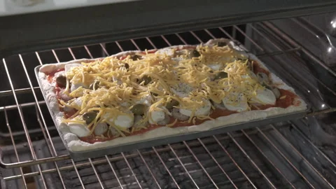 Rectangular homemade pizza with tomato sauce and cheese ready to cook Video stock 330181302