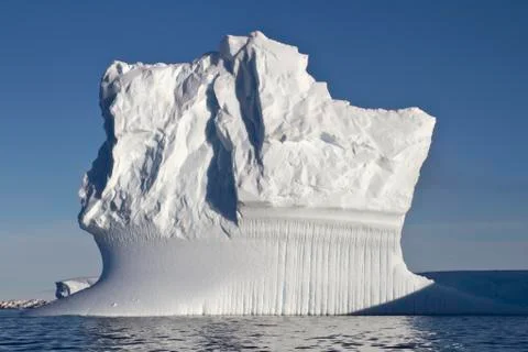 Rectangular iceberg sunny summer day in antarctic waters Stock Photos