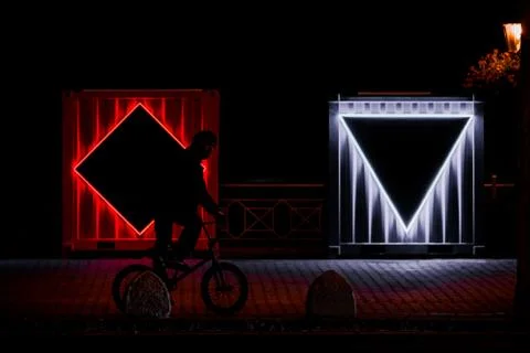 Rectangular industrial boxes with LEDs during night as a part of exhibition Stock Photos