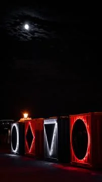 Rectangular industrial boxes with LEDs during night as a part of exhibition Stock Photos