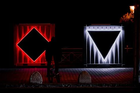 Rectangular industrial boxes with LEDs during night as a part of exhibition Stock Photos