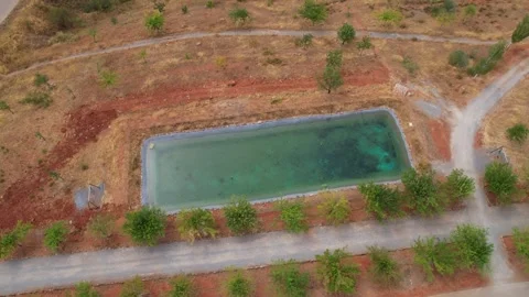 Rectangular irrigation pond excavated in the ground. Aerial view. Spain. 스톡 동영상 328653886