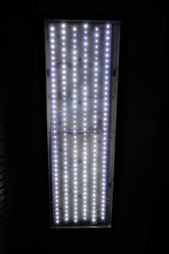 Rectangular LED panel light with neatly arranged bright white glowing dots Stock Photos