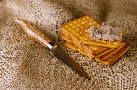 Rectangular liver pate crackers on a burlap sack. Ready-to-eat food. Kitchen  Stock Photos
