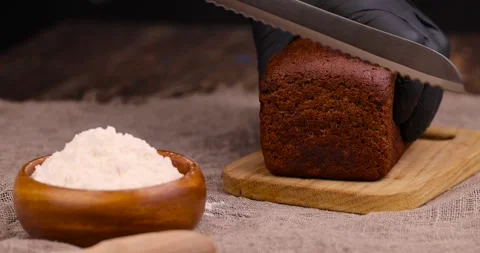 Rectangular loaf of bread on a linen cloth , black bread made from flour Stockbeeldmateriaal 271020832