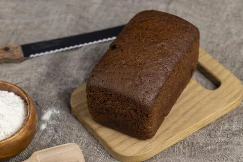 Rectangular loaf of bread on a linen cloth Stock Photos