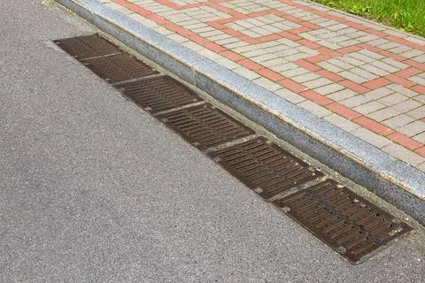 Rectangular manholes of the lattice of the drainage system for drainage. Stock Photos