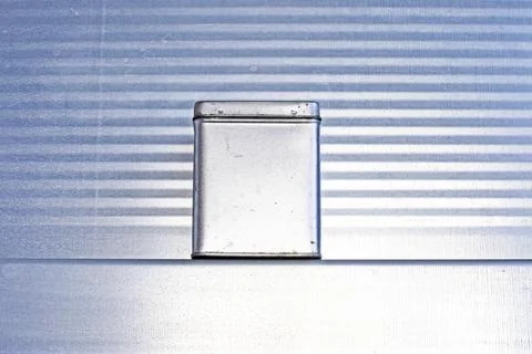 A rectangular metal container for tea and spices on a gray metallic backgroun Foto stock