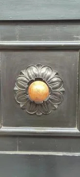 A rectangular metal door with a flower design, showcasing symmetry and artist Stock Photos