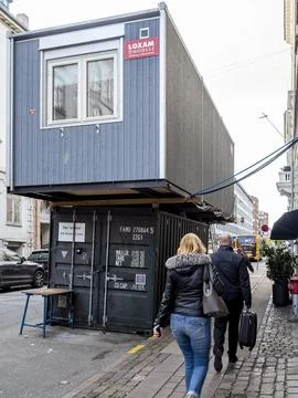 Rectangular modular office stacked on top a shipping container Stock Photos