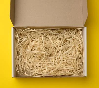 Rectangular open corrugated paper box with sawdust inside. Packaging, contain Stock Photos