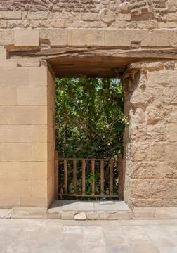 Rectangular opening with wooden balustrade on old abandoned stone bricks wall Stock Photos