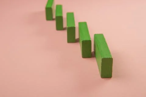 Rectangular pieces of wood in the shape of a ladder on a pink background Stock Photos