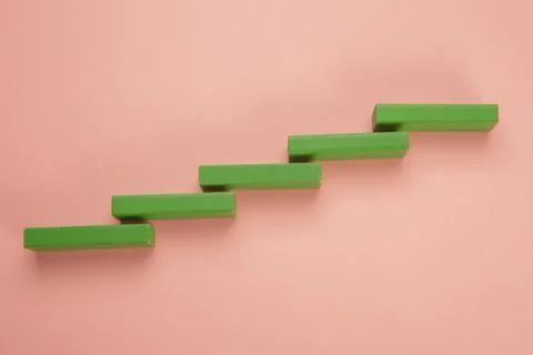 Rectangular pieces of wood in the shape of a ladder on a pink background Stock Photos